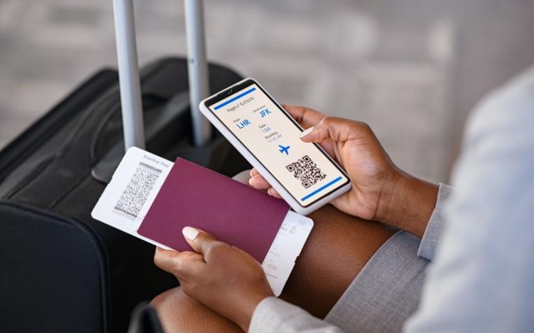 Person checking the flight ticket on their mobile phone. Image credit: Shutterstock/Rido
