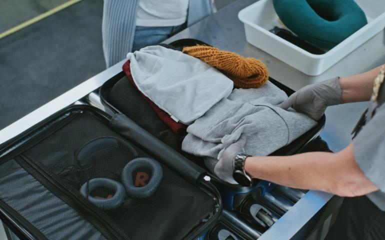 Baggage being checked at the security point of an airport