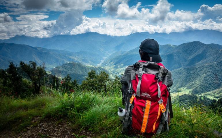 A solo hiker looking towards the valley of Mountains