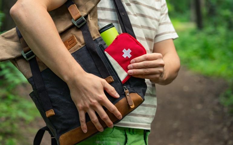 Close-up of a person taking a first aid kit 