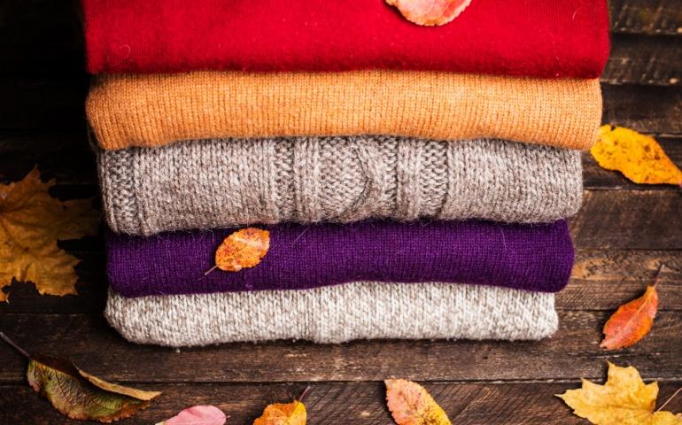 Stack of knitted woolen sweaters