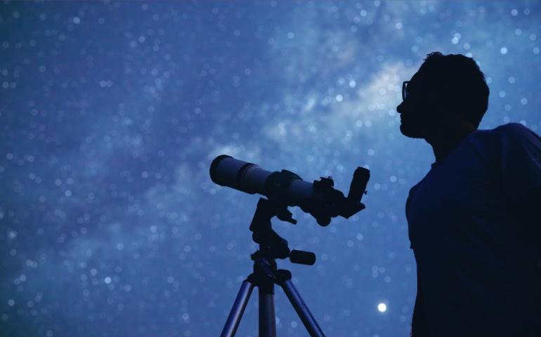 A man stargazing with a telescope 
Image Credit: AstroStar/Shutterstock