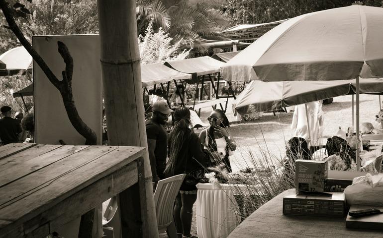 An artistic photo of a group of friends shopping at a farmers' market in Nairobi