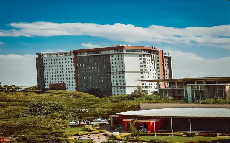 A large building with a green roof and trees in Kenya, Nairobi