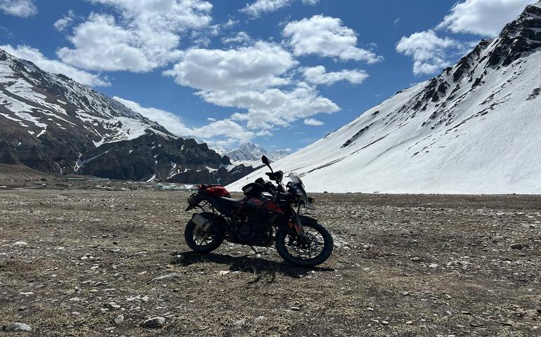 A motorcycle parked in the middle of a barren field