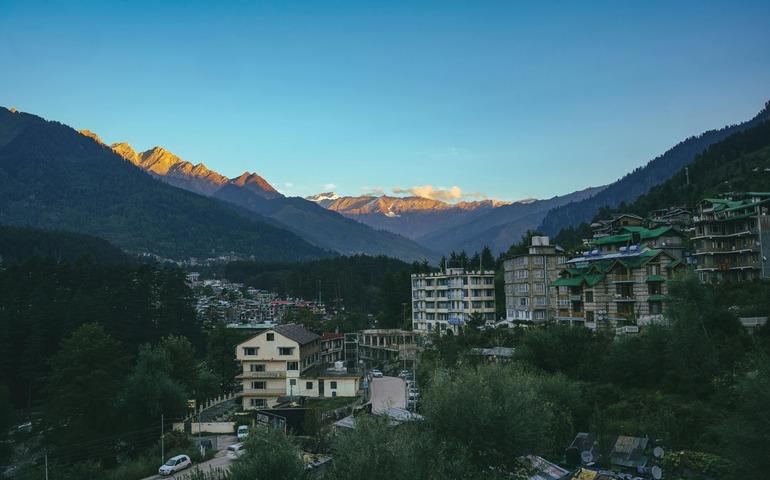 Sunlit Himalayan Mountains Overlooking Manali Town