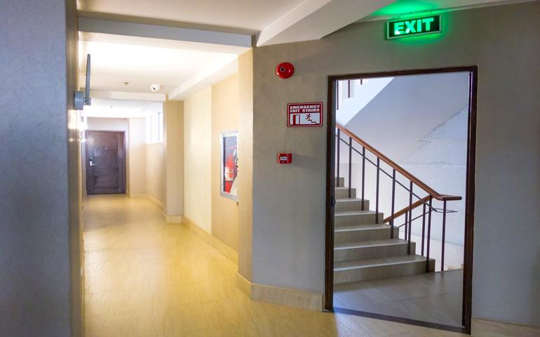 Emergency Exit with Exit Sign and Fire Extinguisher.