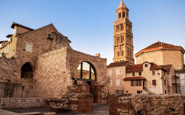 Scene from the old city of Split and the view of old bell tower in sunset