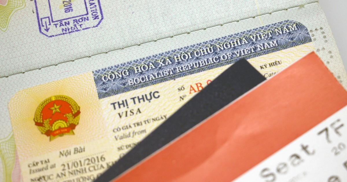 Vietnamese visa sticker on a passport. A visa sticker accompanied with travel documents.