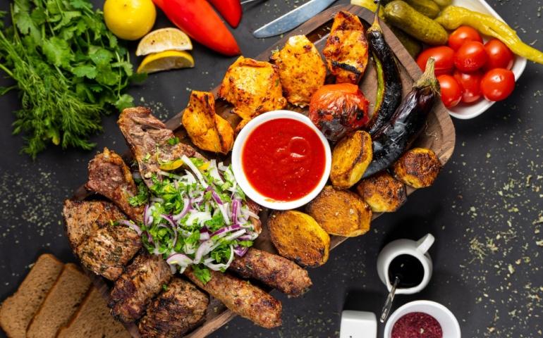 Mixed kebab from Azerbaijan cuisine with fresh salad and sauce
