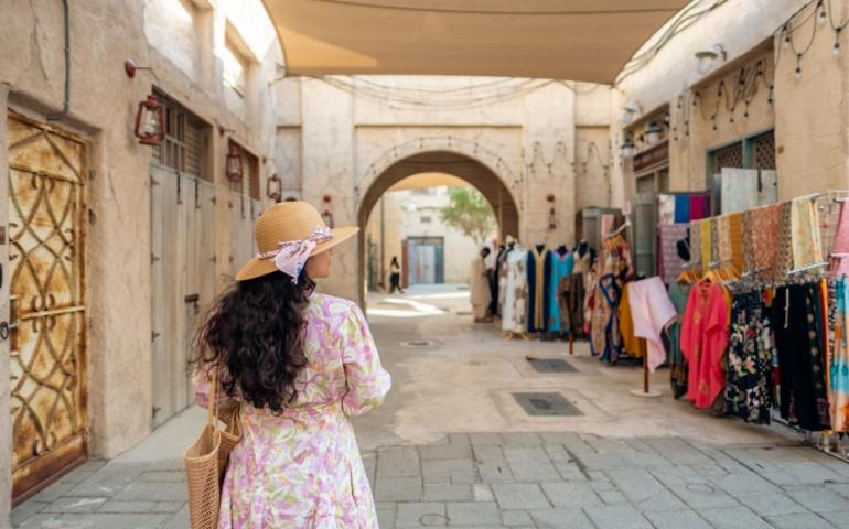 A tourist street shopping at Al Seef Market