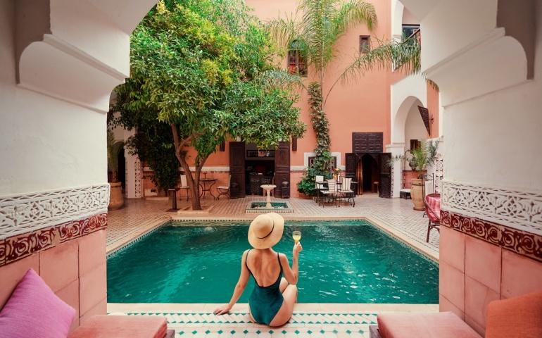 Tourist relaxing in private swimming pool in a beautiful Moroccan riad