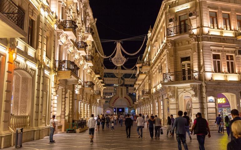 Nizami Street with bright night illumination. Shopping center of Baku