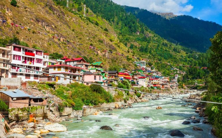Colorful local houses and Parvati river in Manikaran village in Parvati valley, Himachal Pradesh