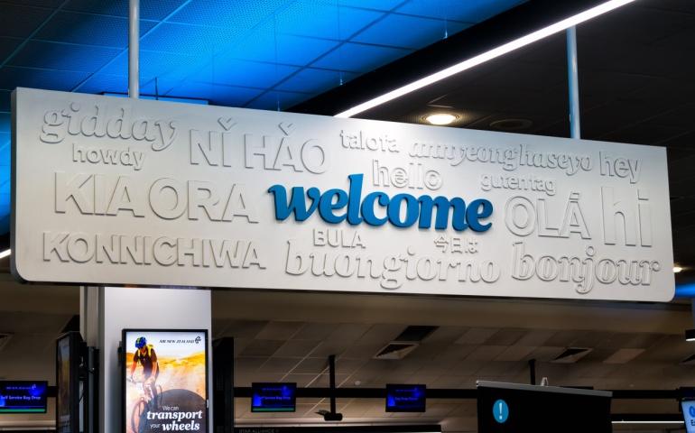 Welcome Sign Greeting Tourists in Many Languages at Auckland International Airport