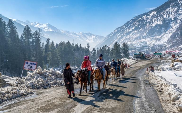 Tourist Riding Horses in Sonamarg Valley during Winter