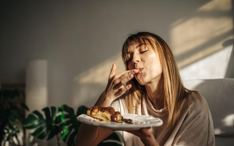 A woman indulging in food without distractions