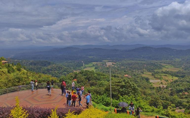 Tourists enjoying the scenic view at the Raja seat in Coorg
