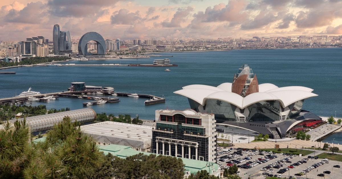 Aerial perspective showcases Deniz Mall in the foreground and the coastline of Baku, Azerbaijan