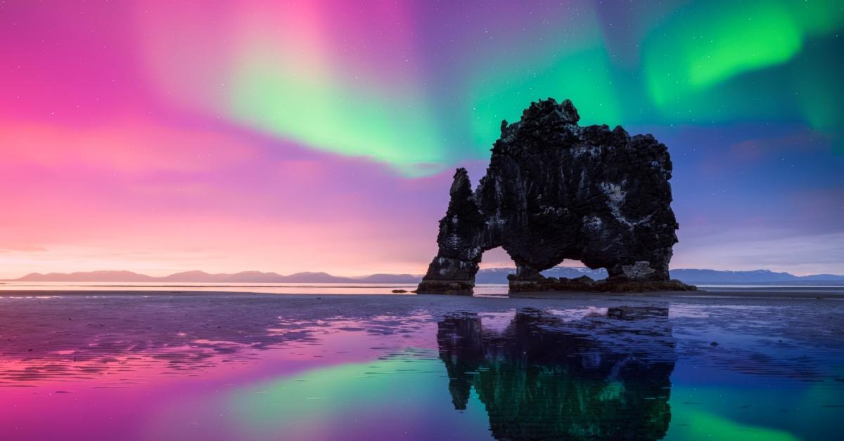 Purple and green Northern lights over Basalt stack Hvitserkur on the Vatnsnes peninsula, Iceland. Gorgeous Icelandic landscape with Polar lights. Aurora Borealis