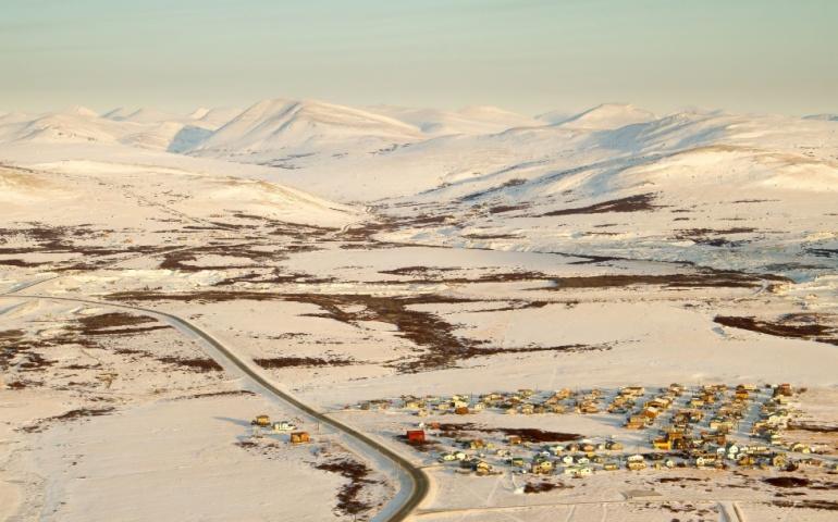 An aerial view of a residential area on the outskirts of Nome, Alaska in the winter
