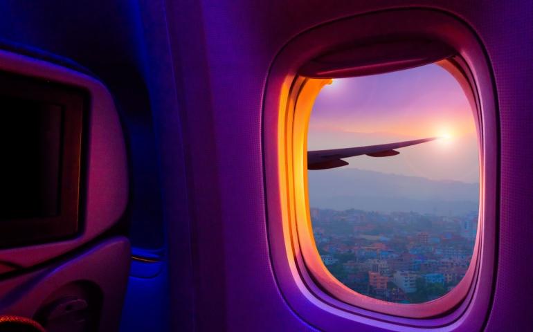 Beautiful scenic city view of sunset through the aircraft window
