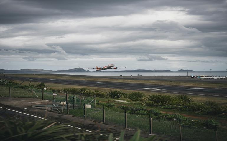 Airplane Takes Off from Coastal Runway