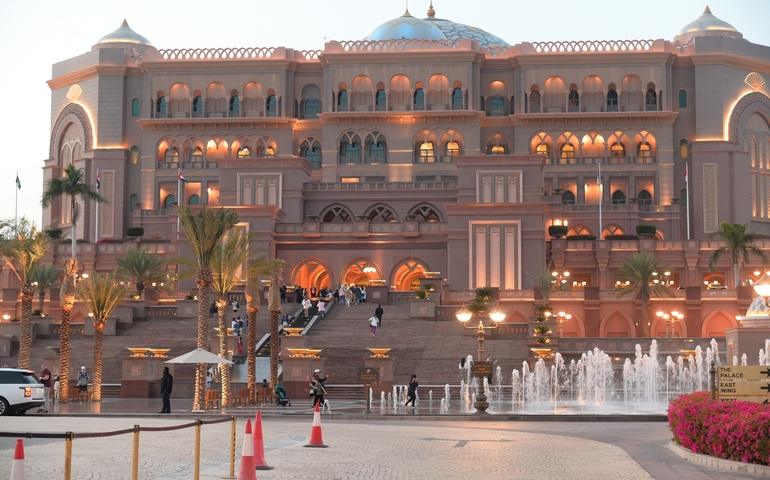View of the Emirates Palace Mandarin Oriental, Palm Trees, and Fountains.