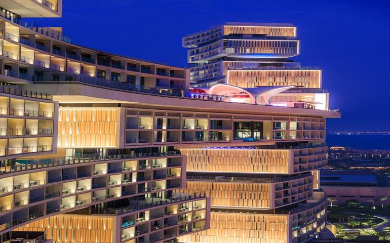 The Atlantis Royal in Dubai illuminted at night with it's own private beach, pools and michelin star restaurants
