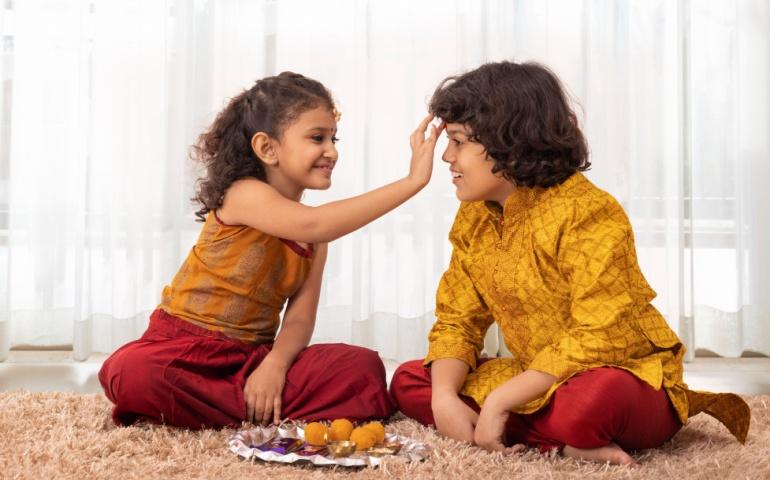 Girl applying Tika for her brother on Bhai Dooj
