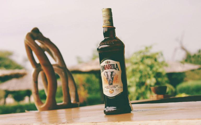 A Bottle of Amarula Drink on Top of a Wooden Table