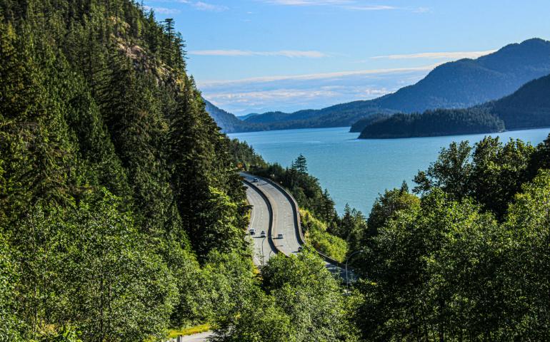 Scenic View of Road with Waterbody Alongside