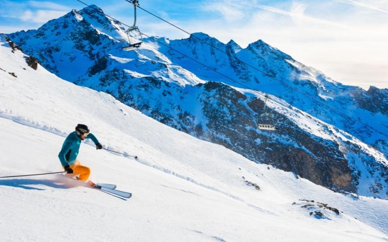 Skier rides down the slope in the French Alps
