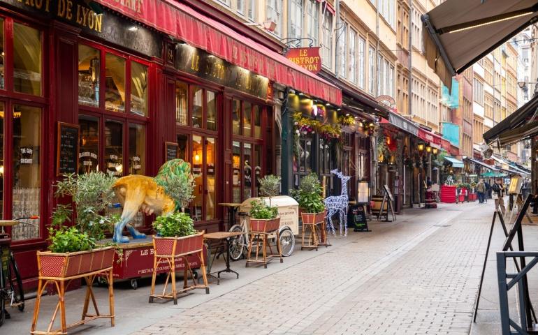 Outdoor seats of French restaurants in the streets of Lyon, the culinary capital of France.
