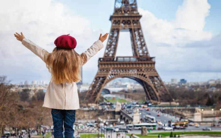 A tourist kid overlooks the Eiffel Tower in Paris, France