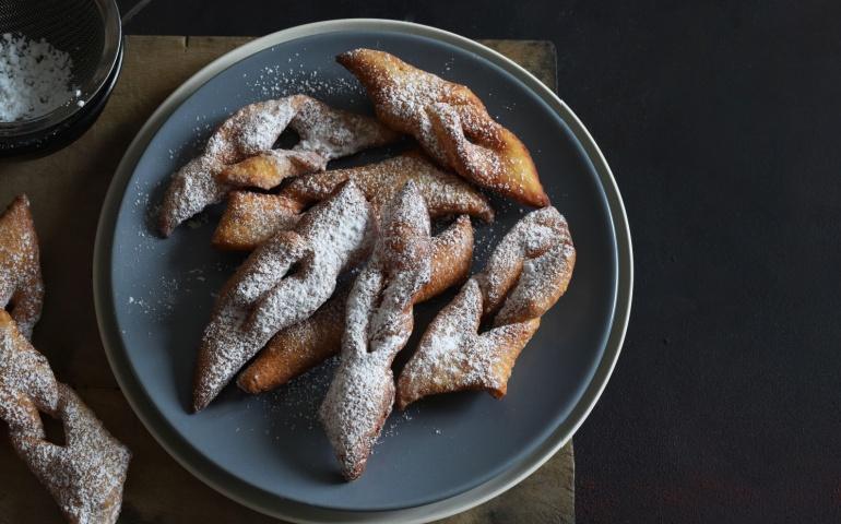 Homemade bugnes from Lyon, sprinkled with icing sugar