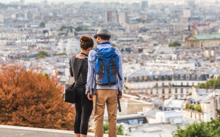 A couple enjoying panoramic views of the city at sunset, Saule Pleureur De La Pointe, Paris