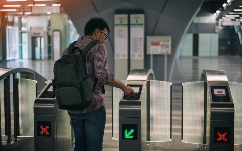 A man tapping his card to enter the metro station
