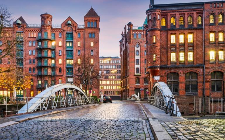 Historic Red Brick Buildings and cobblestone Holländischer Brook Fleet bridge in Hamburg
