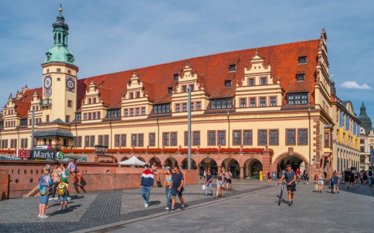Tourists enjoy the sunny summer day at Leipzig’s Market Square, near the historic Old City Hall 
