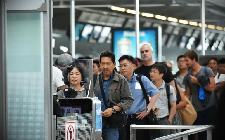 Air travelers queue at immigration control at Suvarnabhumi International Airport