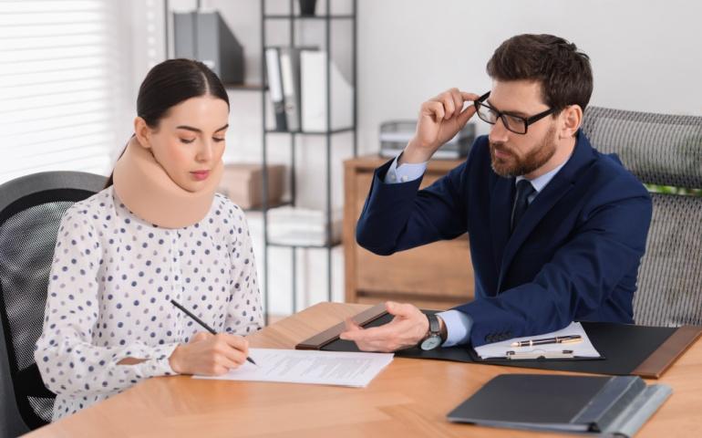 Injured woman signing a document