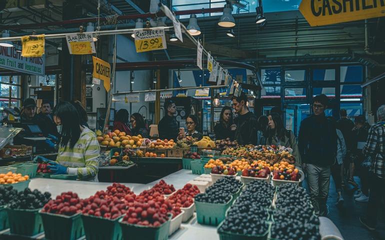 A Group of People around the Fruit Shops in Granville Island Public Market