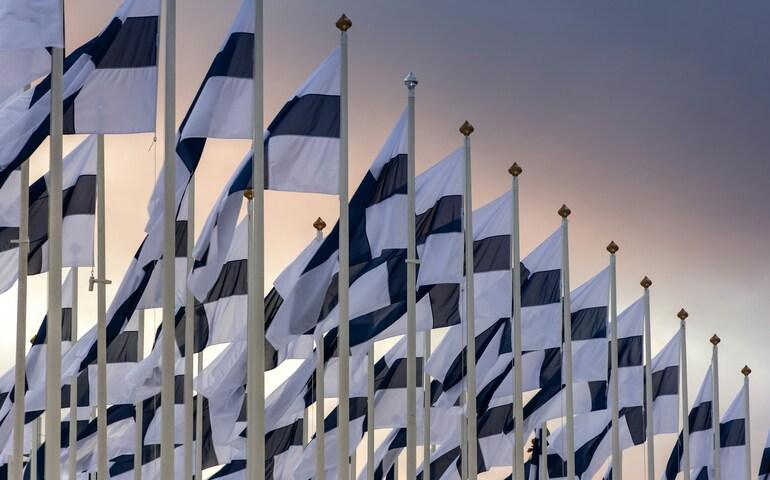 Finland flags in a queue