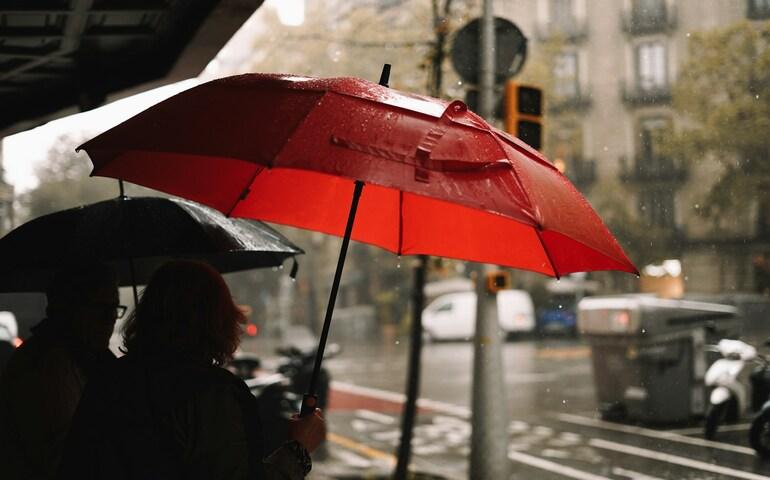 Tourists using an umbrella