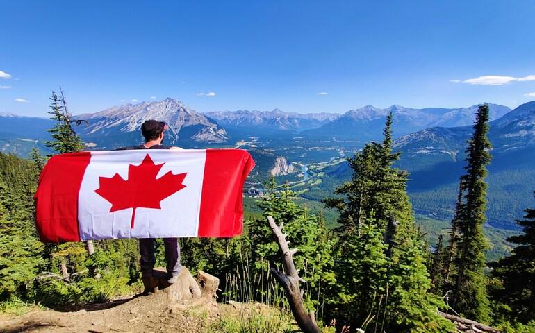 Man holding a Canadian flag