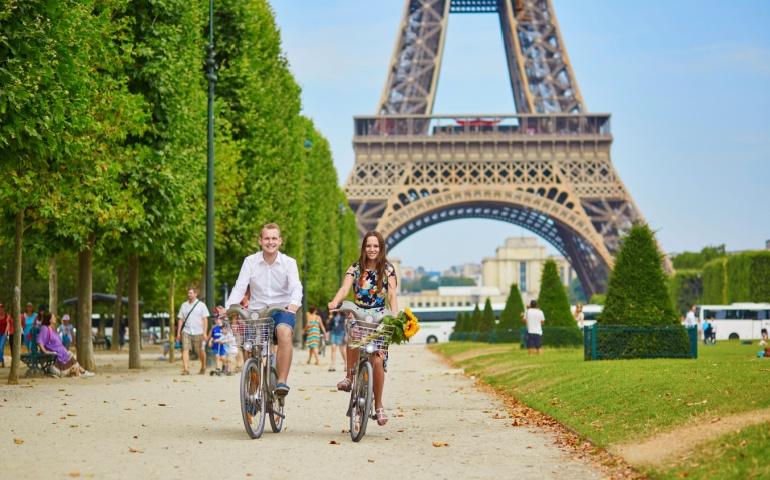 Couple enjoying cycling on the less crowded streets of Paris