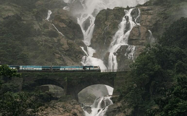 Train passing in front of the Dudhsagar Waterfall