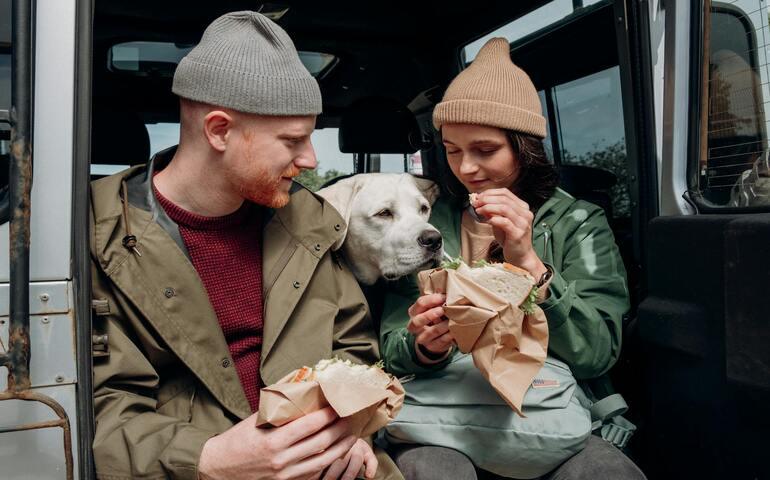 A couple eating in their van