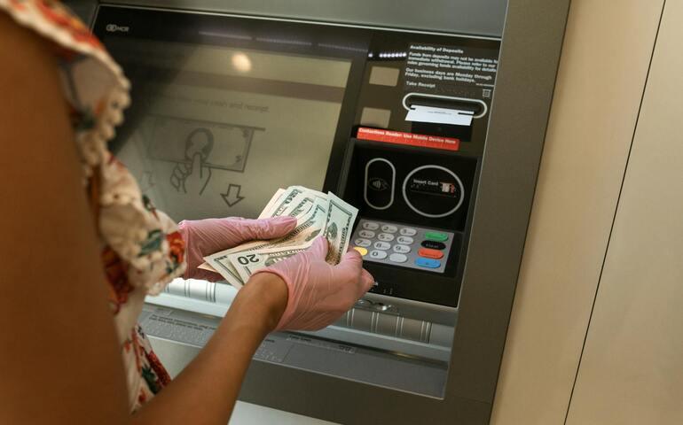 Person removing cash from an ATM